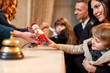 © Svitlana - Where you always feel at home. Happy family checking in hotel at reception desk. Hotel worker is giving a toy for a boy while welcoming guests at the hotel