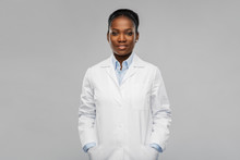 Medicine, Profession And Healthcare Concept - Smiling African American Female Doctor Or Scientist In White Coat Over Grey Background