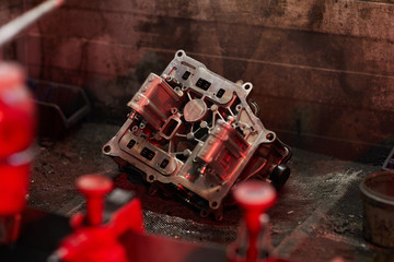 Horizontal shot of modern car motor part lying on auto service garage floor, copy space