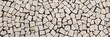 Small bright paving stones. Typical Portuguese floor. Panoramic image