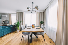 Dining Room With Wooden Table And Floor In Modern Apartment.