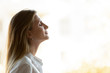 © fizkes - Side view close up head shot young mindful businesswoman breathing fresh air, managing stress at office. Calm peaceful millennial female manager, company owner or team leader meditating at workplace.