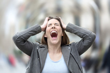 Stressed Woman Suffering Anxiety Attack On City Street