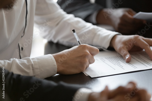 Cuadros en Lienzo Close up young male employee manager customer hands signing paper contract after checking