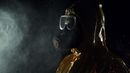 Man in chemical suit with respirator and goggles.