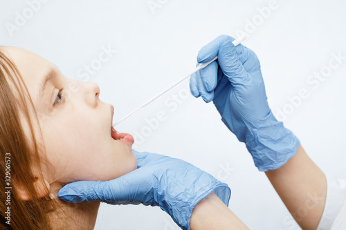 Pediatrician taking saliva test sample