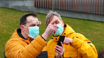 Wall Mural - Couple of men in medical masks try to find their way