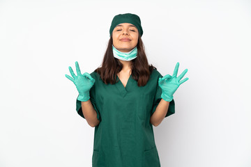 Surgeon woman in green uniform isolated on white background in zen pose