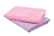 purple and pink towels lie on a white background