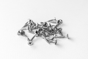 Metal screws on white background.