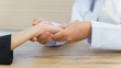 © EduLife Photos - Close up of a doctor holding the patient hands doing basic medical examination and diagnostic.
