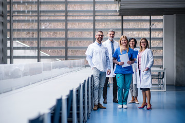 Group of doctors standing in corridor on medical conference.