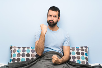 Wall Mural - Man in bed with angry gesture