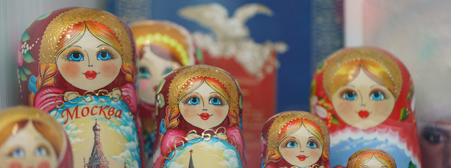 There is a large range of bright colorful Matreshka-dolls (traditional Russian wooden nesting toys) in the store. Red, yellow, green, blue colors.