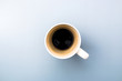 top view of an empty white coffee mug on grey background