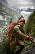 © lightpoet - Young, male climber on a via ferrata route - climbing on a rock in Swiss Alps