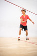 © lightpoet - Squash player in action on a squash court (motion blurred image; color toned image)