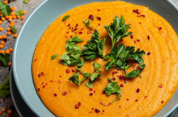 Wall Mural - Indian Dhal spicy curry in bowl, spices, herbs, rustic grey wooden background. Authentic Indian dish. Macro