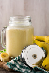 Wall Mural - Banana smoothie in jar on wooden table	