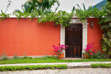 Carved wooden door in colonial house of La Antigua Guatemala, exterior detail shows security and private property, access to home.