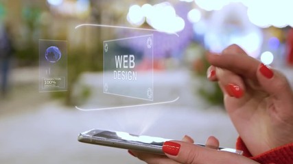 Female hands interact with HUD hologram text Web Design. Woman with red nails and sweater uses the holographic technology of the future in the smartphone screen on the background of street