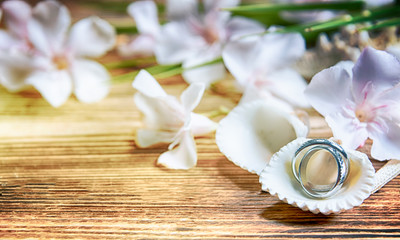 Wall Mural - Wedding rings on the wooden background