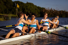 Teammates Rowing On The Water