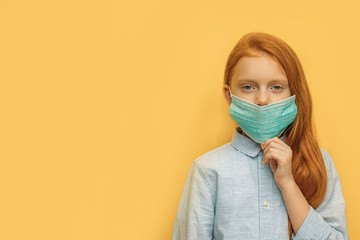 portrait of ill caucasian red haired girl with protective mask on face, unhealthy girl suffer from fever, coronavirus. she protects others and herself with the use of medicaments and protective mask