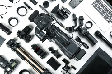 Wall Mural - flat lay composition with video camera and other equipment on white background