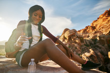 African American Woman Hiker At Red Rock Canyon Reaching For Water Bottle