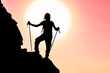 silhouette of successful climber at the top