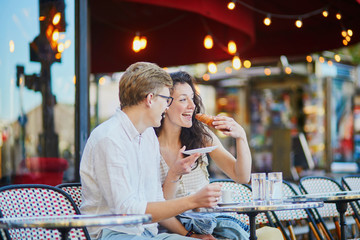 Happy romantic couple in Paris, drinking coffee