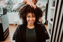 Beautiful Latin Woman With Short Curly Brown Hair Getting A Treat At The Hairdresser. Latin Hairdresser Working Her Afro Hair. Lifestyle