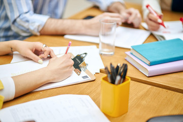 Cropped image of a psychiatrist odr business woman making notes during meeting, conference, paper work, job, profession