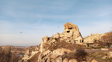 Ancient stone cave houses carved into the volcanic rock in Cappadocia, Turkey