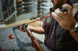 © Nomad_Soul - Man cleans rifle barrel at counter in gun shop