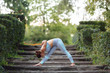 © onphotoua - Pretty smiling young sexy woman doing yoga exercises in the park