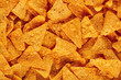 Heap of Mexican nachos or tortilla chips as texture background