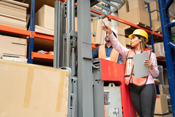 Female And Male Coworkers Working At Factory