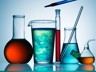 Wall Mural - different laboratory glassware with color liquid and with reflection
