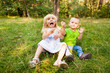© justesfir - Funny little girl and boy making faces outdoors in summer