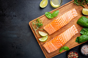 Sticker - Raw salmon fillet and ingredients for cooking, seasonings and herbs on a dark background . Top view