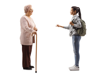 Wall Mural - Female student talking to a senior woman with a walking cane