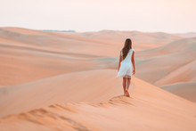Girl Among Dunes In Desert In United Arab Emirates