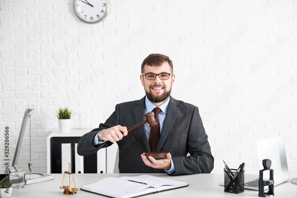 Male lawyer sitting at workplace in office