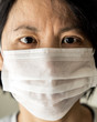 © Kenishirotie - Head to shoulder portrait of a China woman in a medical mask to protect from flu virus
