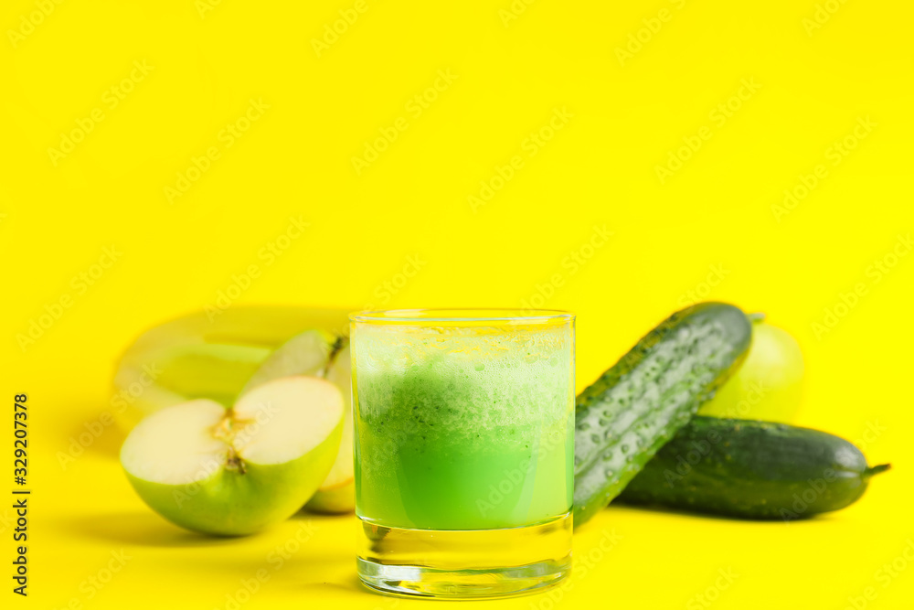 Glass of fresh vegetable juice on color background