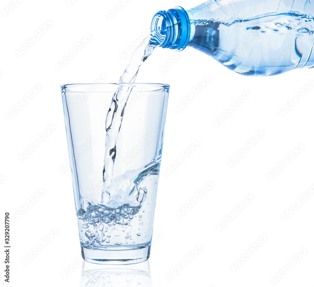 Pouring of fresh water in glass on white background