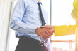 © Bigc Studio - Business people shaking hands standing with colleagues after meeting or negotiation business man and business woman teamwork partnership and handshake success Man and woman are shaking hand in office