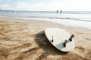 Wall Mural - Surfboard on beach background and people. Travel adventure and water sport. relaxation and summer vacation concept.